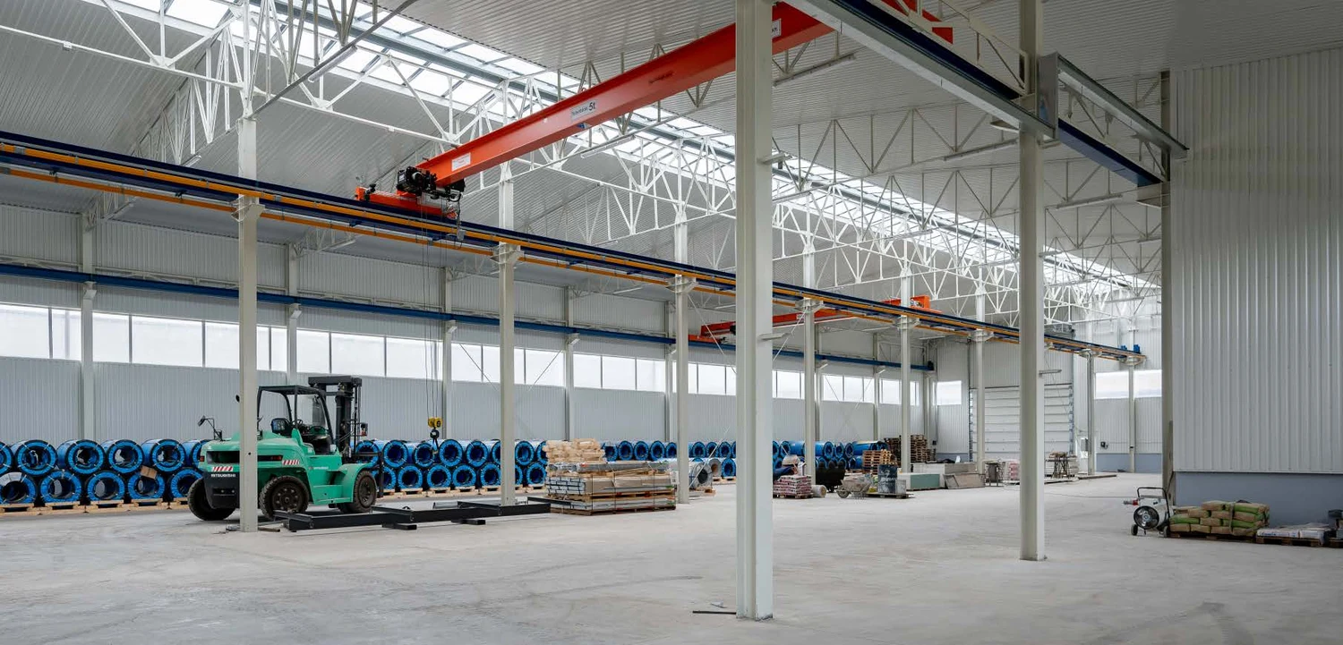 Wide photo of the industrial hall with crane and forklift